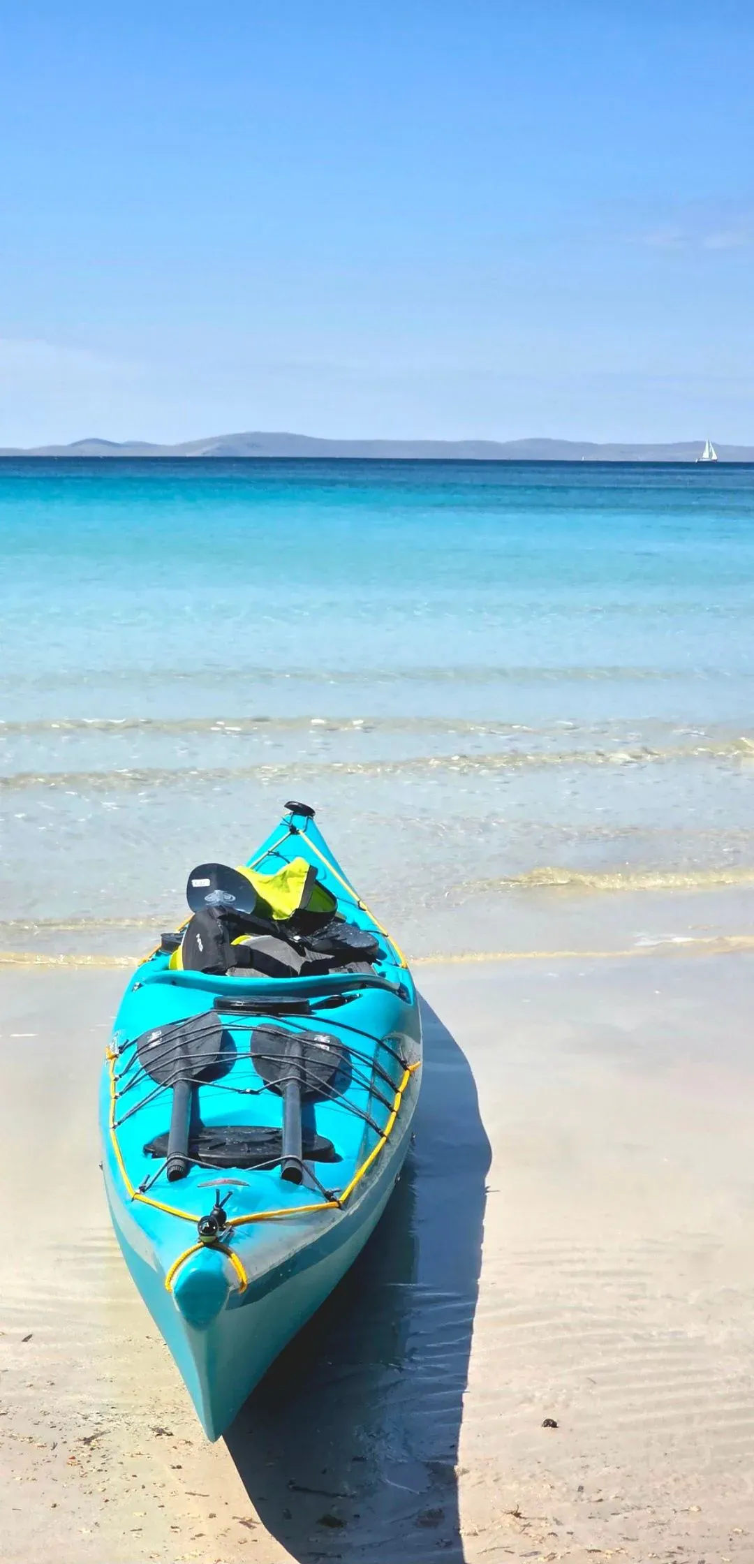 Sea kayak resting on a sandy beach